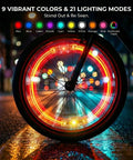Bicycle wheel with Rechargeable 9 Color LED Bicycle Spoke Lights With 21 Modes And Motion Sensor Auto On Off lit in multi-color at night