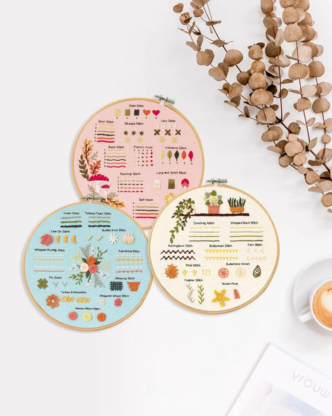 Beginner Embroidery Kit Set for Adults and Teens, Learn 30 Plus Stitches With Clear Instructions and Video Tutorials, DIY Cross Stitch Kit Includes Hoop, Pattern Cloths, Color Threads, Needles, Tools, Pin Cushion and Thread Picker. Three embroidery hoops with stitched patterns and stitch guides displayed on a table.