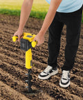 Person using Cordless Post Hole Digger For Urban Greening And Farm Planting Battery Powered Hole Digging Machine in field.