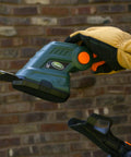Cordless Grass Shear And Shrub Trimmer With Wheeled Extension Handle Seven Point Two Volt Lithium Ion Battery in use close-up