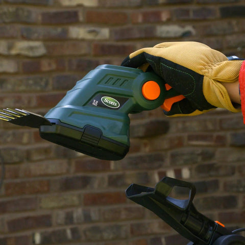 Cordless Grass Shear And Shrub Trimmer With Wheeled Extension Handle Seven Point Two Volt Lithium Ion Battery in use close-up