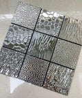 Stainless Steel Peel And Stick Backsplash Tiles 10 Sheets 3D Carven Silver Easy Self Adhesive Wall Decor For Kitchen Bathroom And Fireplace No Grout Required Durable Waterproof Finish Modern Metal Look. Close-up of textured tile designs.