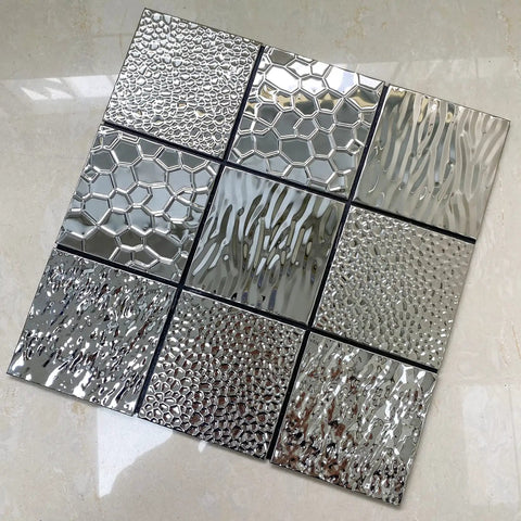 Stainless Steel Peel And Stick Backsplash Tiles 10 Sheets 3D Carven Silver Easy Self Adhesive Wall Decor For Kitchen Bathroom And Fireplace No Grout Required Durable Waterproof Finish Modern Metal Look. Close-up of textured tile designs.