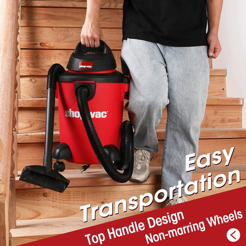 Person carrying Heavy Duty 6 Gallon Wet Dry Vacuum With 3.0 Peak HP, 3 In 1 Function, Dual Flex Hose on wooden staircase