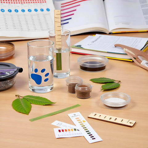 pH Test Strips Kit 1 To 14 With Storage Case For Water Soil Urine Saliva Pet Food And Diet Monitoring on a wooden table