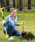 Woman gardening with Manual Twist Tiller For Gardening With Seventeen Inch Arc Handle And Ergonomic Grip in a lawn.