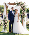 Wedding couple standing under 7 Foot Wooden Garden Arbor Trellis With Wide Arch And Strong Side Trellises For Climbing Plants.