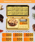 Pocket Digital Gram Scale 300g Capacity With 0.01g Precision lying open showing ginger roots, 50g calibration weight, and digital readout