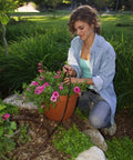 Gardener using 1 GPH Pressure-Compensating Drip Emitter 30 Pack Spot Watering Dripper For One Quarter Inch Tubing Self-Piercing Design