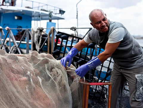 Man wearing Atlas 660 Triple Dipped PVC Chemical Resistant Gloves With Workhorse Grip and Seamless Cotton Liner on fishing boat