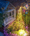 41 Inch Tall Solar Watering Can With LED Lights Garden Stake featuring butterfly and flower accents illuminating a garden path