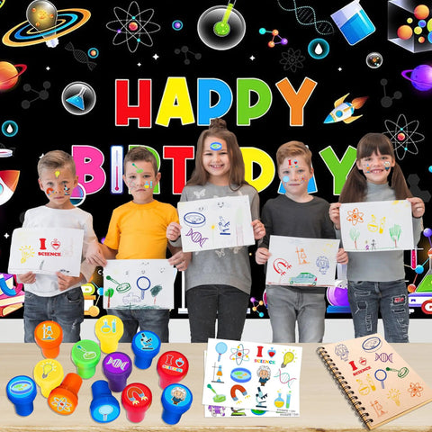 Children holding drawings with science-themed party favors set, including 12 stamps and 24 temporary tattoos, against a birthday backdrop.