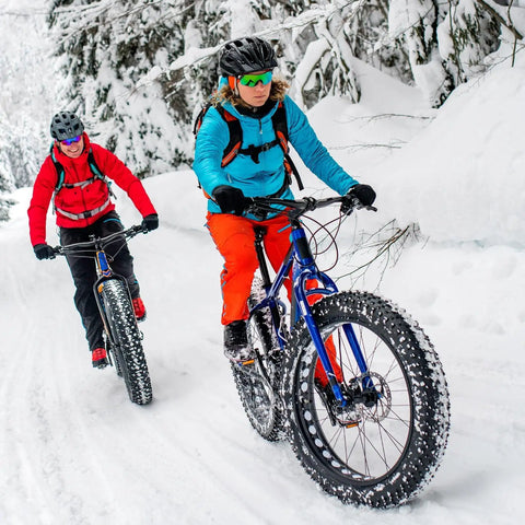 Two cyclists riding fat bikes with Heavy Duty 2 Pack Fat Bike Inner Tubes 24x4.0 to 4.5 AV32mm Schrader Valve on snow trail