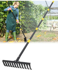 Heavy Duty Garden Rake With 78 Inch Handle And Twisted Tooth Tines 12 Metal Head Rake used for leaf cleanup in garden scene