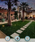 Garden with pathway lit by 4 inch diameter in ground well lights with grated top 3000K warm white low voltage lamps, solid bronze housing.