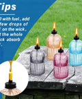 Glass Tabletop Torch Set Four Pack For Outdoor Use With 13.5 Oz Citronella Fuel on wooden table outdoors