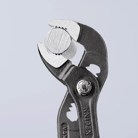 Cobra Pliers With One Handed Adjustment And Guard, shown gripping a metal object, detail of hardened teeth for strong grip.