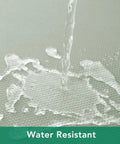 Close-up of water being poured on a 54x54 Inch Sage Square Tablecloth, Linen Like, Water Resistant And Washable, showing water resistance.