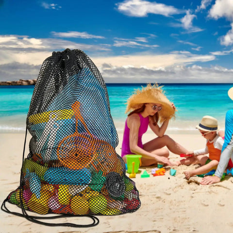 3 Pack Mesh Dive Bags Oversized 19x27 Inch Drawstring Snorkel Gear Bags filled with beach toys on sand by ocean