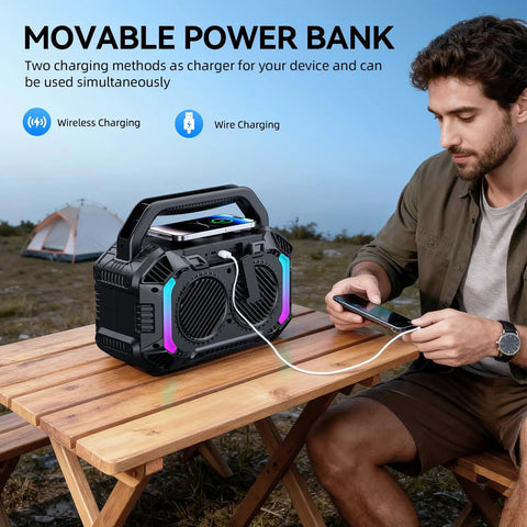 Man charging phone with Beast 100W Bluetooth Outdoor Speaker With IPX7 Waterproof Floatable Design on picnic table