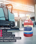 Heavy Duty Low Foam Auto Floor Cleaner, Straight Up Pro Grade Concentrate in front of an auto scrubber, one gallon jug.