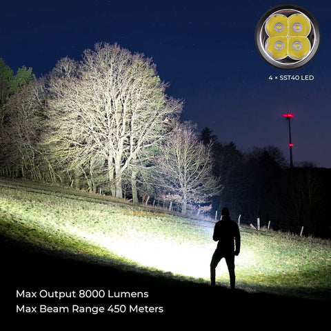 SP36 Pro Rechargeable LED Flashlight 8000 Lumens, 4X SST40 6500K, night use in outdoor setting, silhouette in beam
