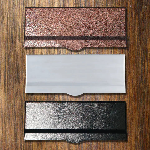 Three letter plates including a Black Aluminum Letter Plate For Liberty Chute, Heavy Duty Front Door, displayed on a wooden surface.