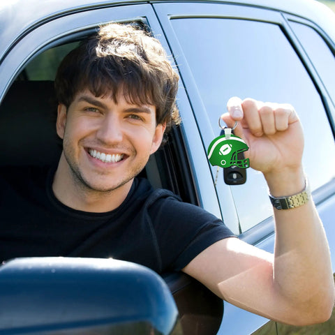 Person in car holding Helmet Shape Sublimation Keychain Blanks Kit, 20 Pieces With Rings And Clips For DIY Ornaments
