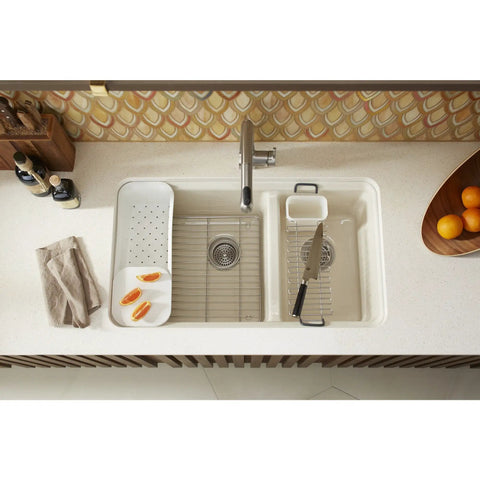 Riverby White Rinsing Colander With Built In Cutting Board on sink edge, ideal for pasta and veggies, with drain holes and dual function