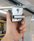 Hand holding 2 Piece Adjustable Garage Door Top Bracket Kit Made Of Galvanized Steel With Anti Oxidation Finish For Home Renovation