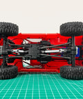 2 Pack Steel CVD Driveshafts For 1 To 18 TRX4 M K10 F150 RC Crawler Upgrades Silver Beefy Heavy Duty Connection For Smooth Power Transfer And Precision Fit Ideal RC Crawler Upgrade For Stability And Durability, underside view of red 1/18 RC crawler chassis with steel driveshafts