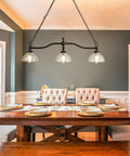 3-Light Kitchen Island Pendant Light Fixture With Clear Glass Shades Rustic Black Farmhouse Chandelier in a dining room