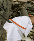 Person using 60 Pack 16 By 19 Inch Terry Bar Mop Rags For Cleaning Absorbent And Durable Cotton Cloths Multipurpose Shop Towels in garage