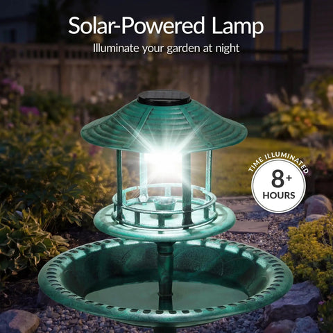 Solar Outdoor Bird Bath With Resin Pedestal Fountain In Green Yard Garden Decor illuminated at night with solar lantern