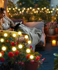Woman relaxes with Solar Garden Lights Outdoor 4 Pack Firefly Swaying Lights Waterproof Garden Decor illuminating cozy patio.