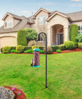62 Inch Outdoor Shepherds Hook Bird Feeder Pole With 5 Prongs Base in garden, holding bird feeder, in front of house