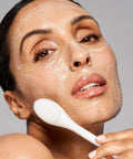 Model using Pore Polishing Wand Silicone Facial Cleansing Brush Game Changer Dual Sided Face Scrubber for gentle exfoliation