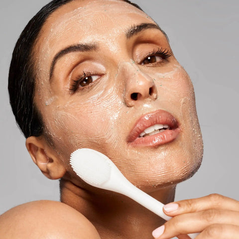 Model using Pore Polishing Wand Silicone Facial Cleansing Brush Game Changer Dual Sided Face Scrubber for gentle exfoliation