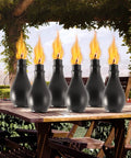 Six Pack Outdoor Metal Torches With 3 Prong Grounded Stakes Extra Large 59 Inch Citronella Torches displayed on a patio table