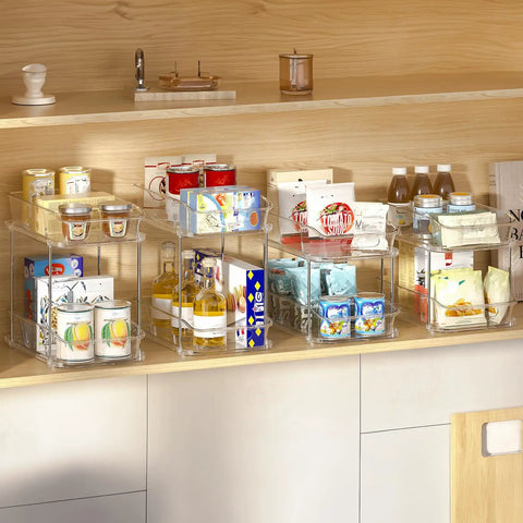 Slick Clear Under Sink Organizers And Storage Bins 2 Pack With High Low Design For Bathroom Cabinet Decluttering Pantry Organization, featuring stacked bins with various goods.
