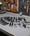 Six Pack Black Zipper Repair Kit Set With Metal Slider Universal Fix For 3 Zip Sizes scattered on a workbench.