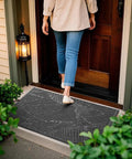 All Weather Outdoor Doormat With Simple Stripes Waterproof Non Slip Heavy Duty Front Door Mat For Indoor Garage And Patio Dark Grey 29 By 17 Inches Now placed at a front door with a person walking over it.