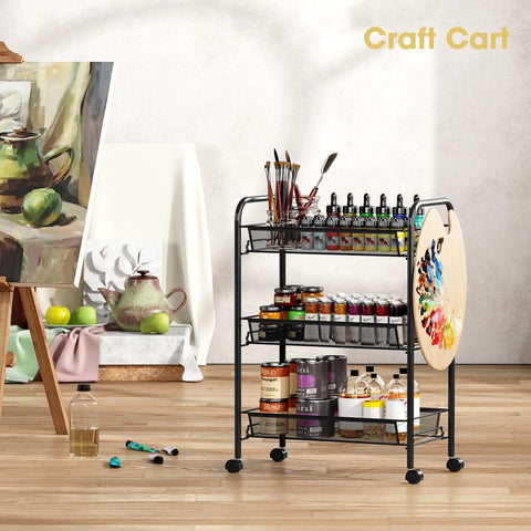 Three Tier Metal Rolling Cart With Mesh Wire Shelving And Wheels filled with art supplies in an art studio, showing side hooks.