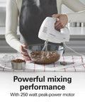 Hamilton Beach 6 Speed Electric Hand Mixer With Quick Burst And Bowl Rest Snap On Storage Case mixing chocolate batter in glass bowl