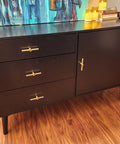 Brushed Brass Cabinet Knobs 4 Pack T Bar Cabinet Pulls Gold Finish 3.9 Inch Length on black sideboard in living room