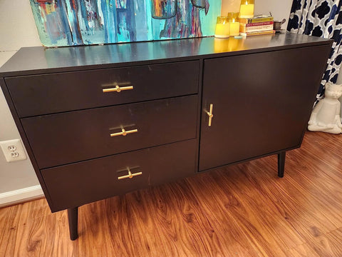 Brushed Brass Cabinet Knobs 4 Pack T Bar Cabinet Pulls Gold Finish 3.9 Inch Length on black sideboard in living room