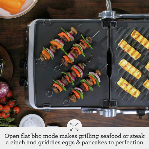 Breville Stainless Steel Electric Grill Panini Maker With One Touch Presets grilling vegetable skewers and grilled pineapple slices.