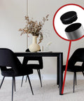 Close-up of 1 Inch Outer Diameter Ribbed Plastic Hole Plugs for round tubing on chair legs, preventing floor scuffs in dining room.