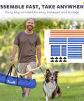 Man carrying 4 Piece Dog Agility Course Set with adjustable height hurdles and blue carry bag, outdoor setting
