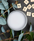 Top view of Manatee Gray Chalk Finish Furniture Paint for DIY Lovers surrounded by eucalyptus and Scrabble tiles